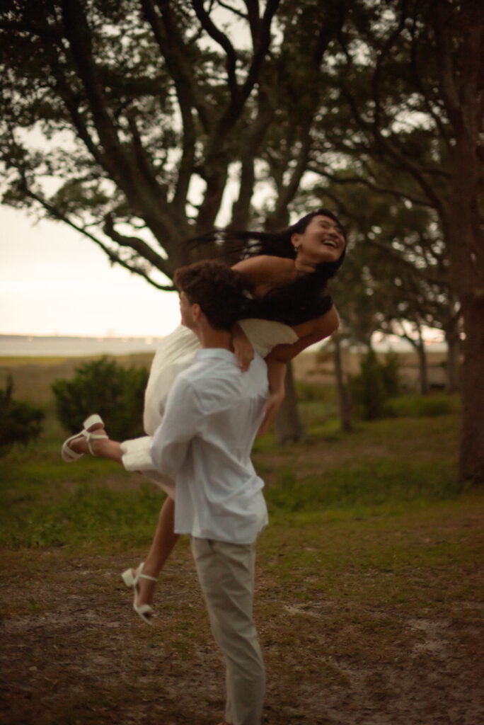 Cinematic coastal boardwalk elopement in North Carolina photographed by A Visual Anthropologist”

“Coppola prosecco and cake picnic setup with red floral accents at North Carolina elopement”

North Carolina elopement photography