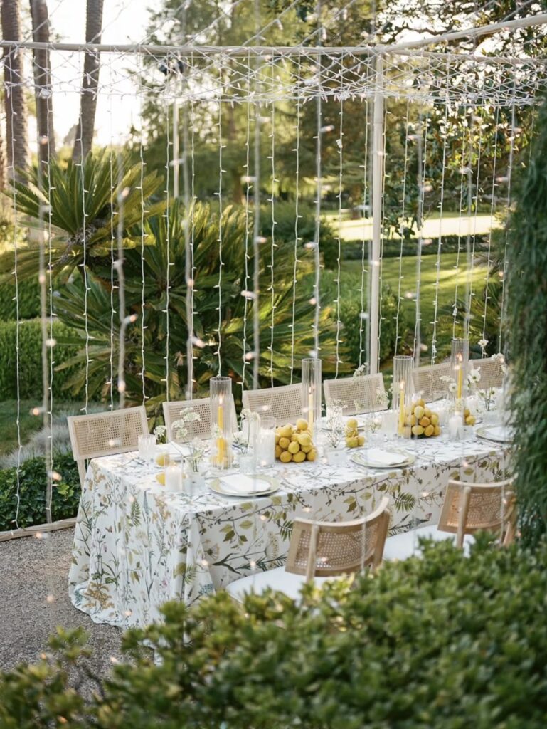 Alfresco wedding table with lemon centerpieces and candlelight designed by Laurel and Fey at Lloyd Butler Ranch.”