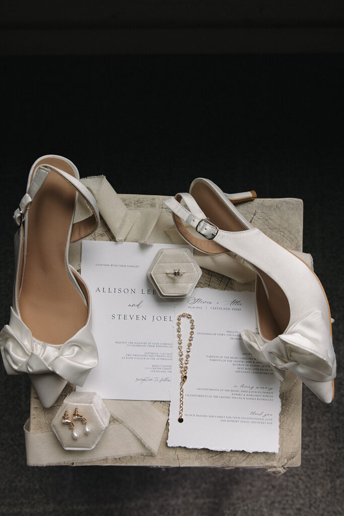 modern bridal details with white heels and invitation suite