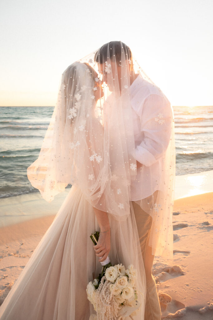 Bride and groom sharing a private vow renewal moment on the beach at sunset
Bride and groom exchanging vows during intimate Emerald Coast vow renewal