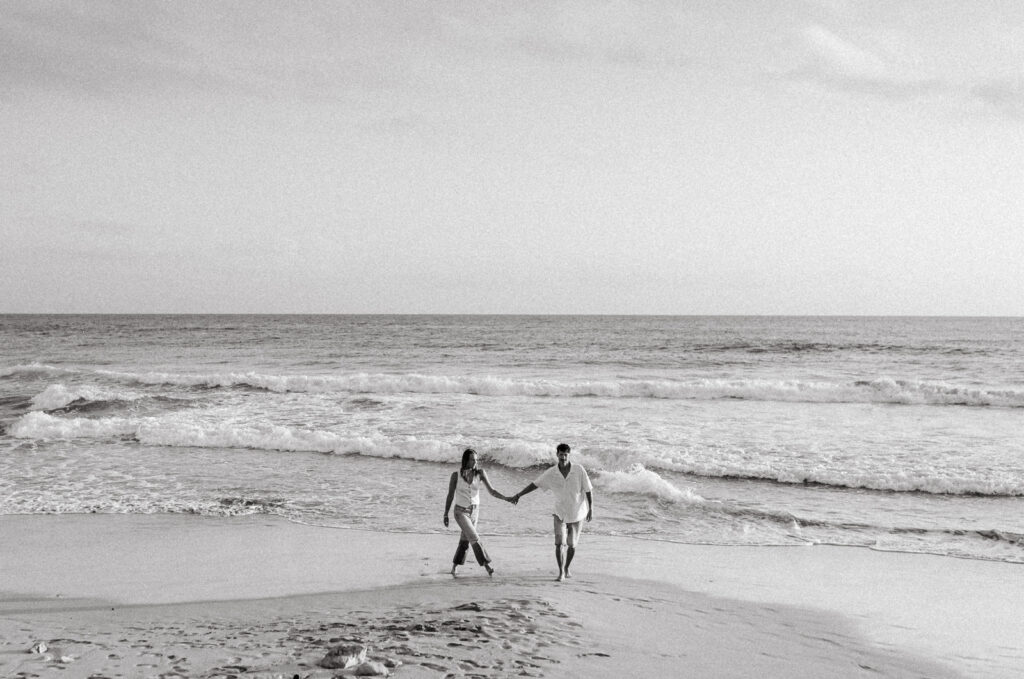 Black and white anniversary couple photo by the sea in Menorca, Spain
Wide coastal shot of couple standing together in the water during a Menorca anniversary session
