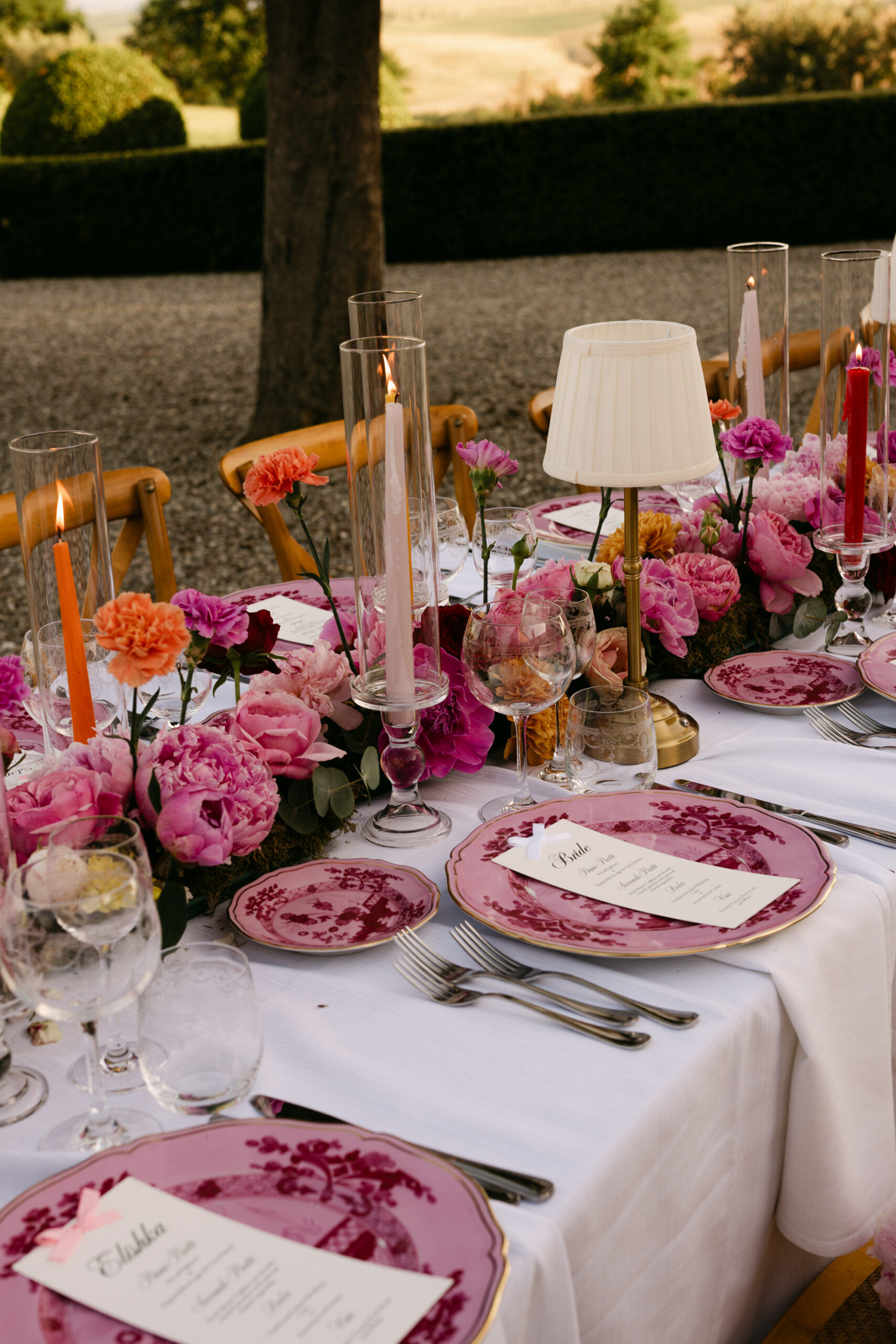 Close detail of pink Oriente Italiano Ginori 1735 charger plates and peonies, Italian destination wedding tablescape