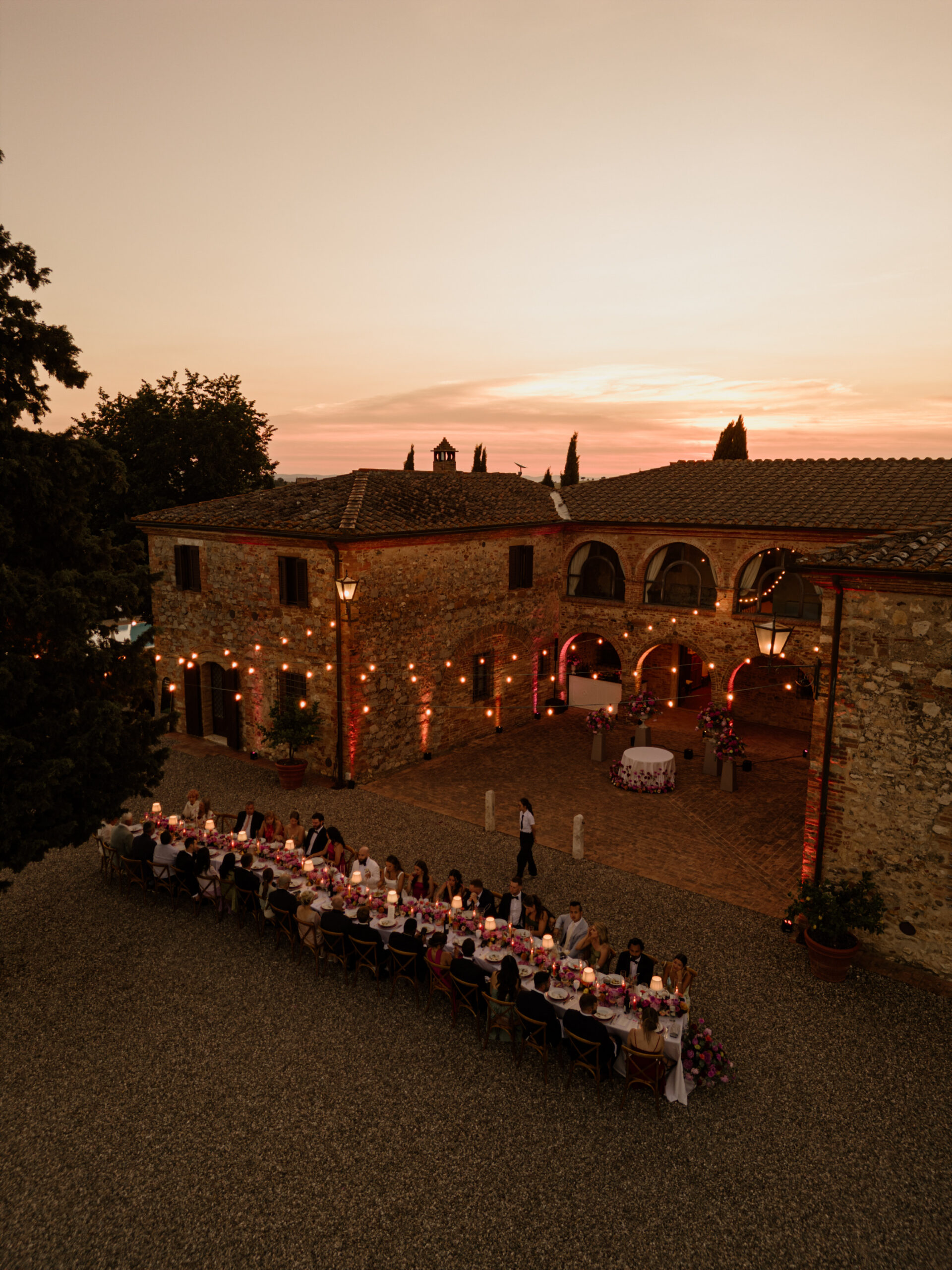 Villa Boscarello lit at dusk, three day destination wedding in Val d Orcia Tuscany