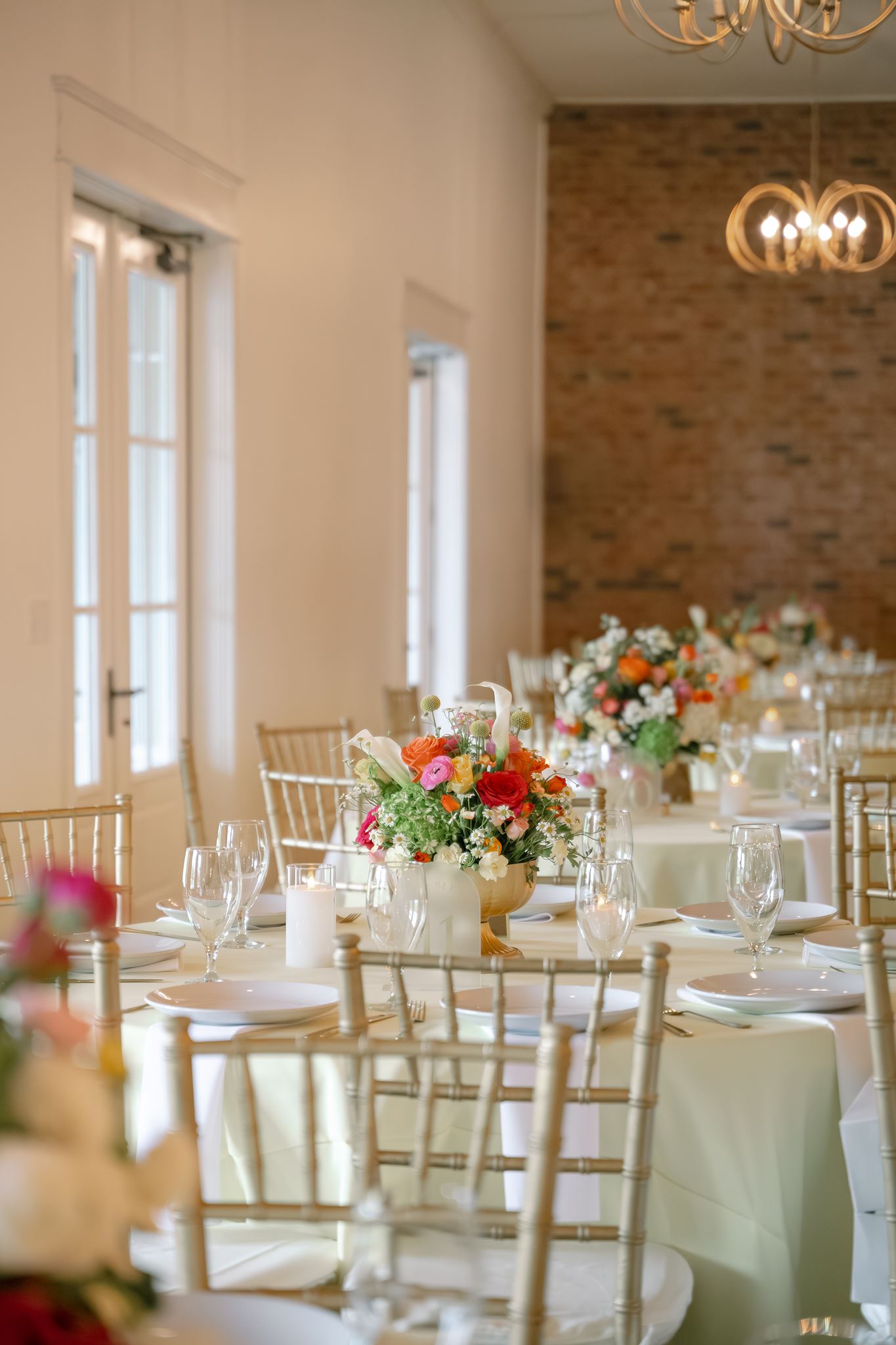 Reception table with colorful spring centerpiece at Hazelnut Farm
