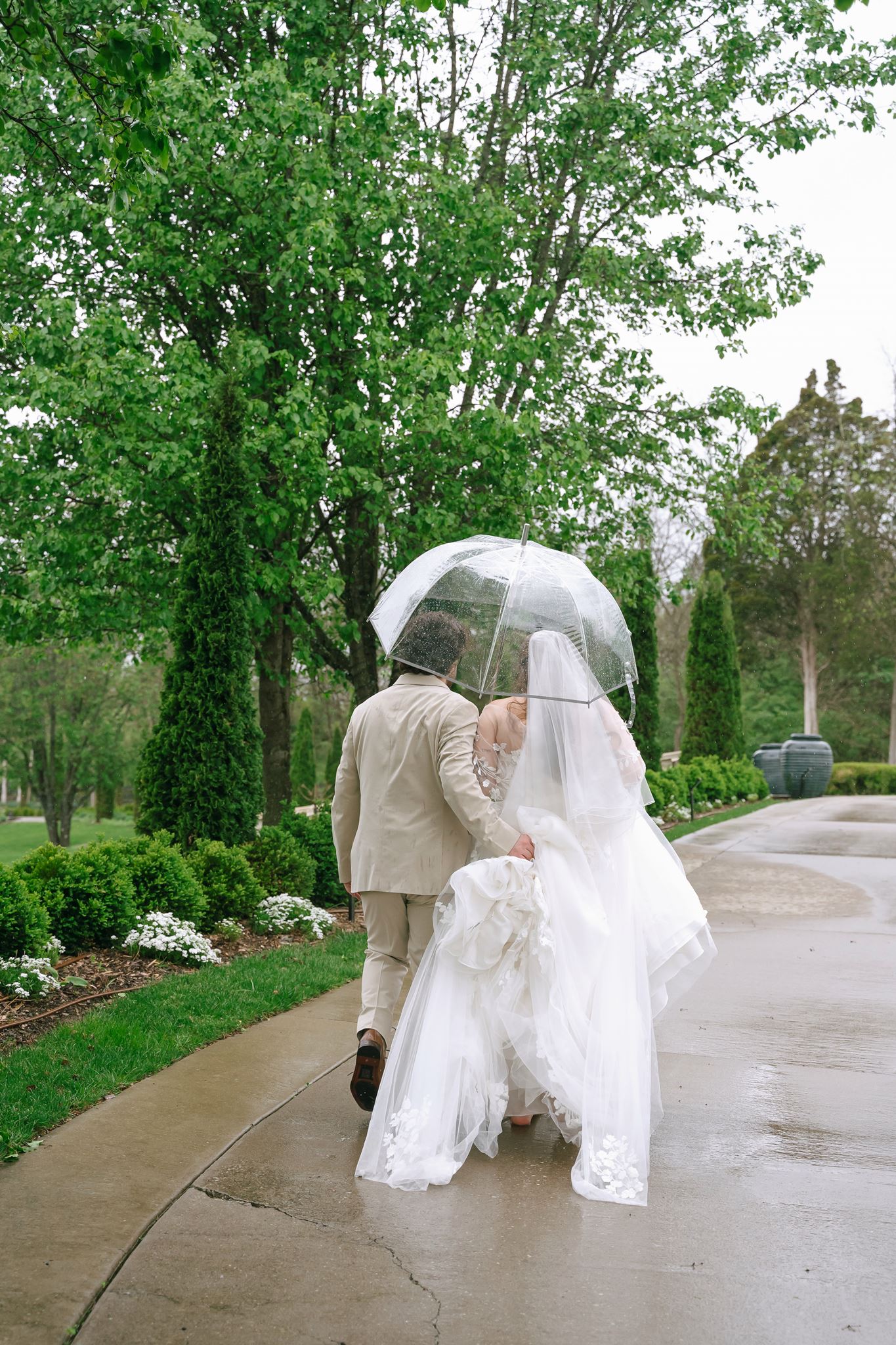 Couple walking under a clear umbrella in the rain