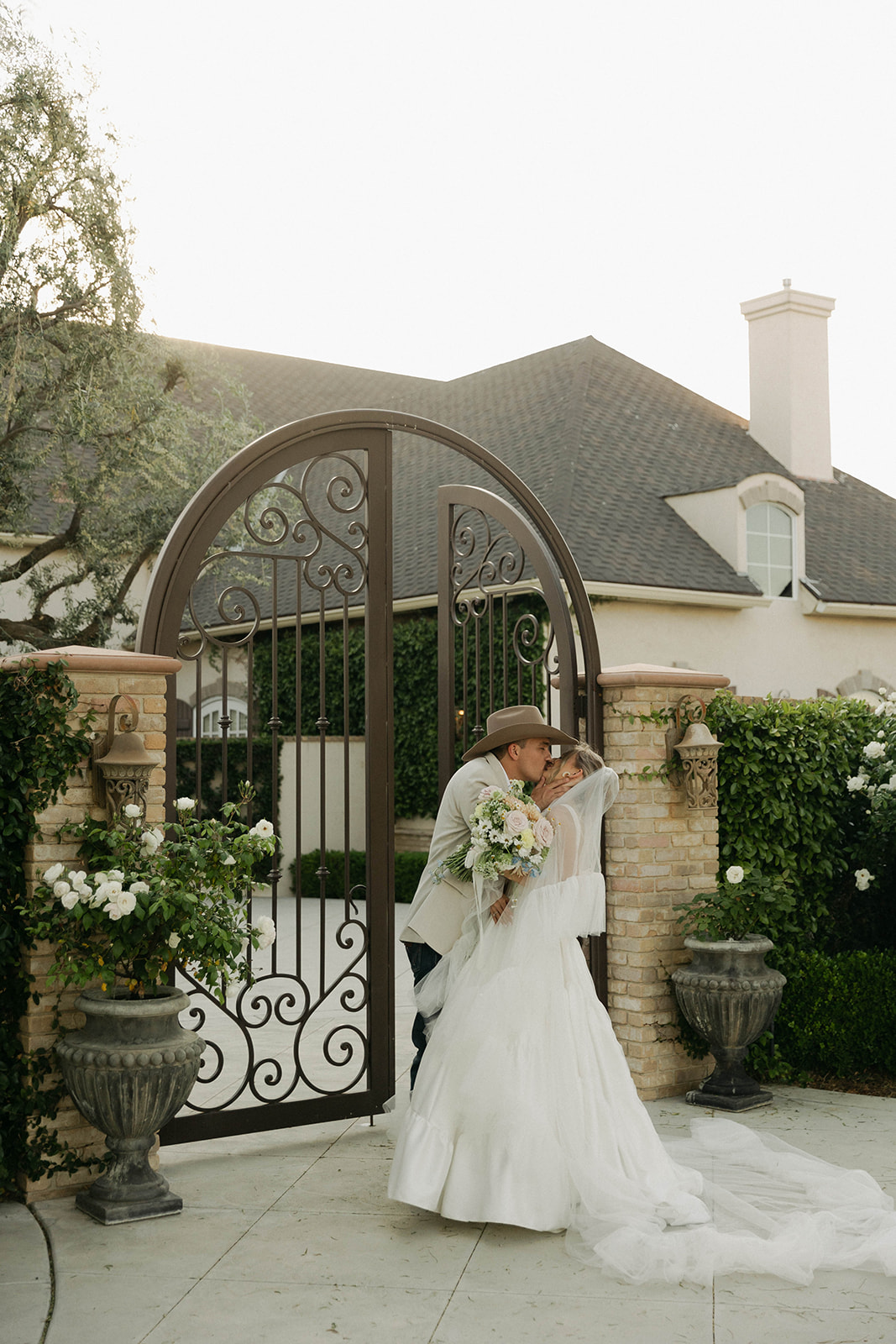 Couple kissing at the gate of the Nirvana Estate in Bakersfield