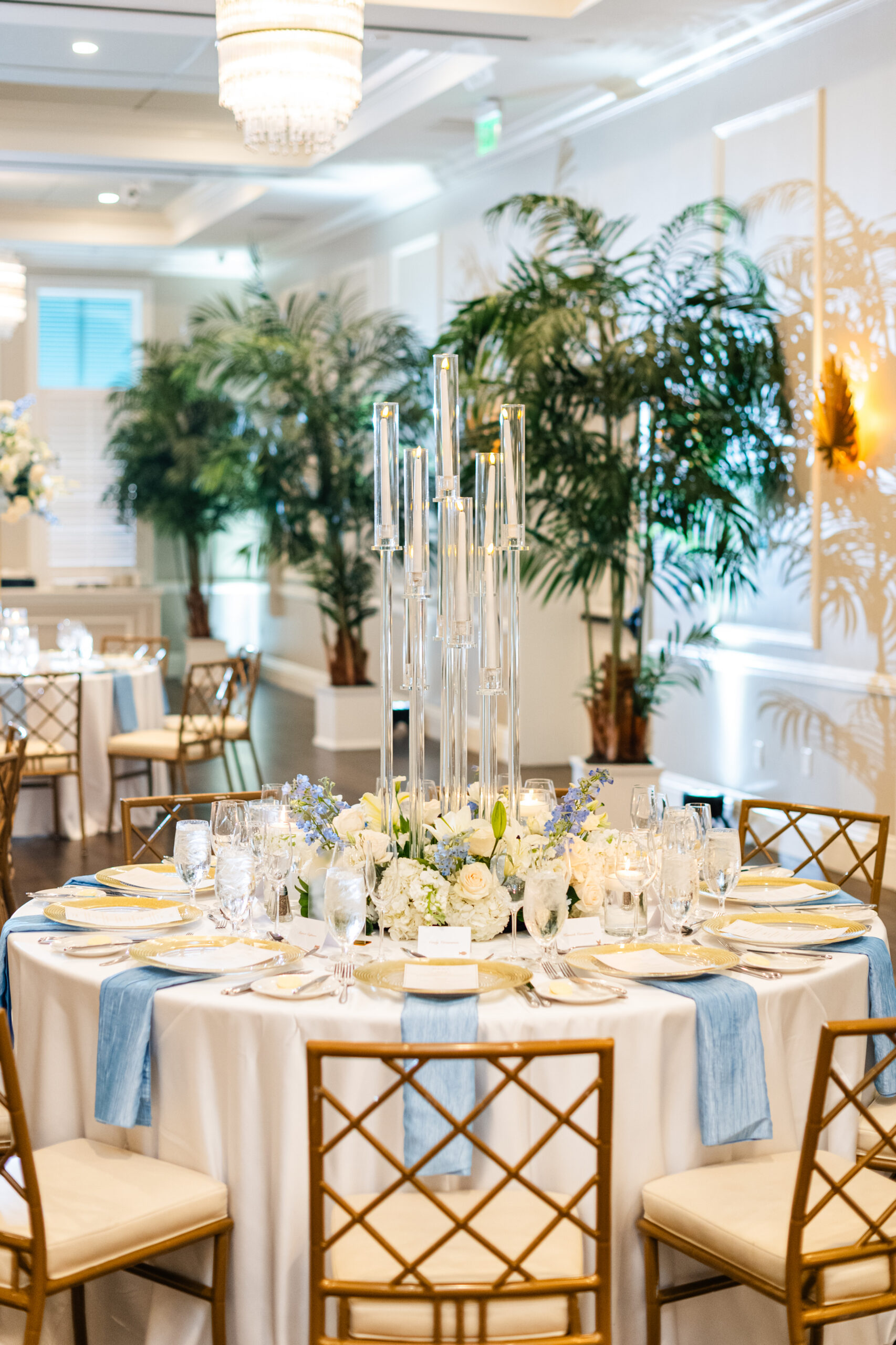 Reception tablescape with crystal candelabra and coastal blue and white florals