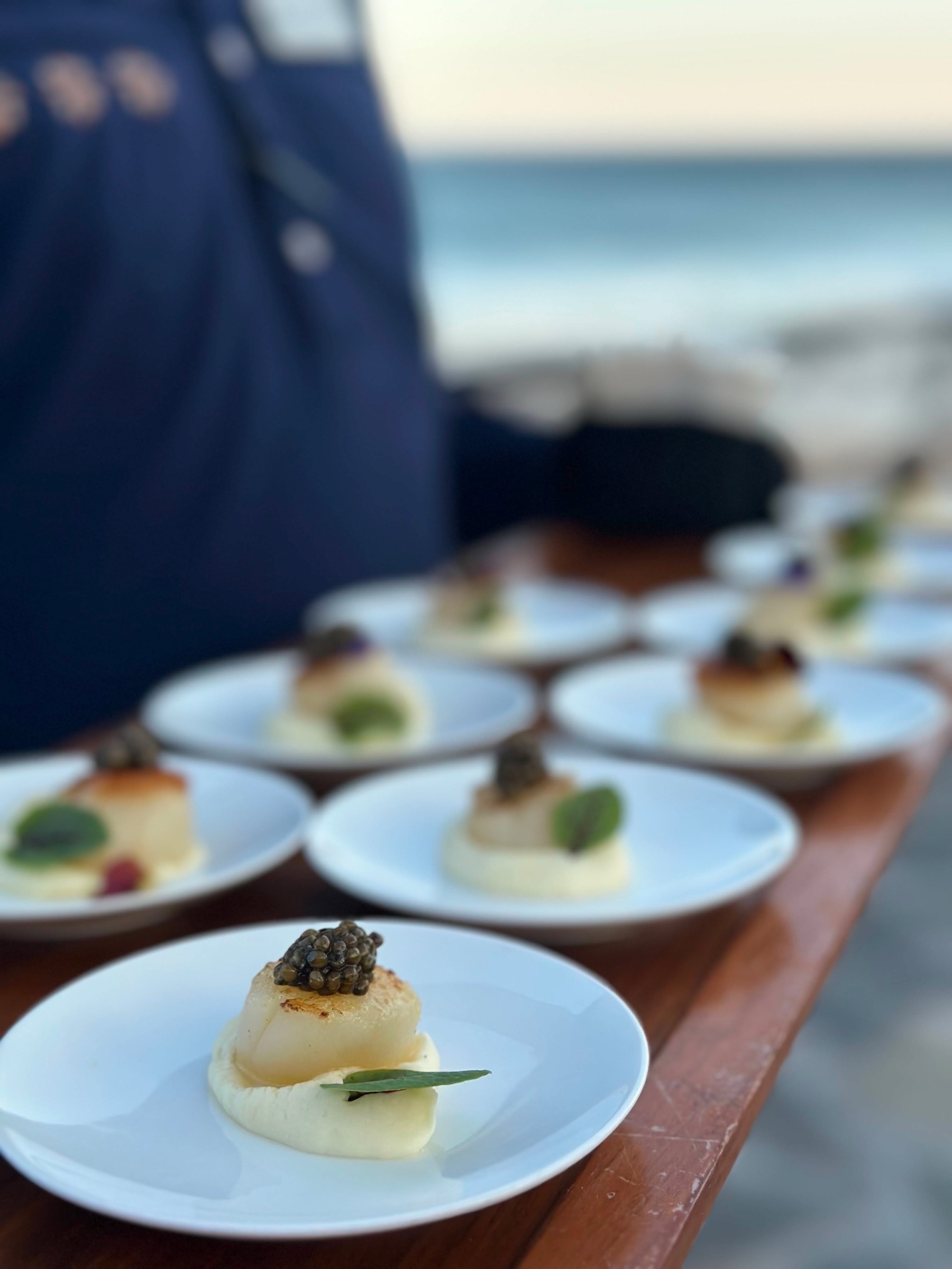 Seared scallop and caviar canapés by the sea