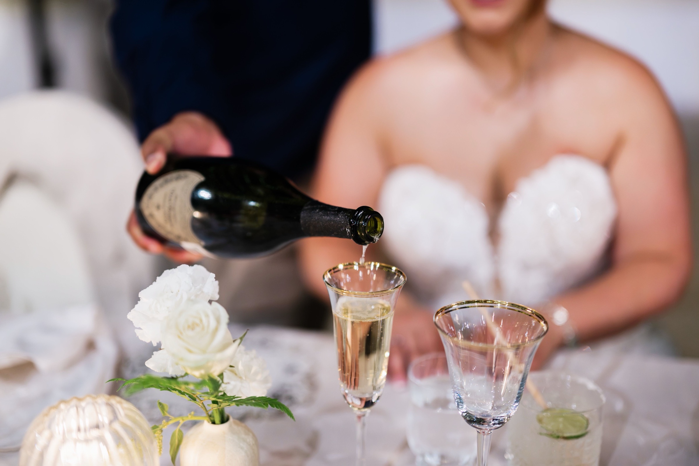 A Dom Pérignon toast poured into gold rimmed flutes