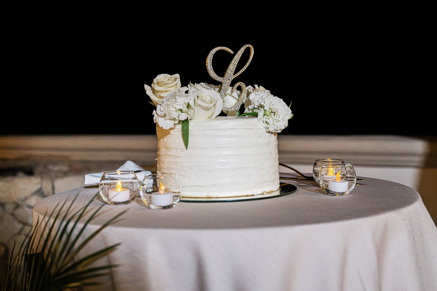 Three tier wedding cake with monogram topper