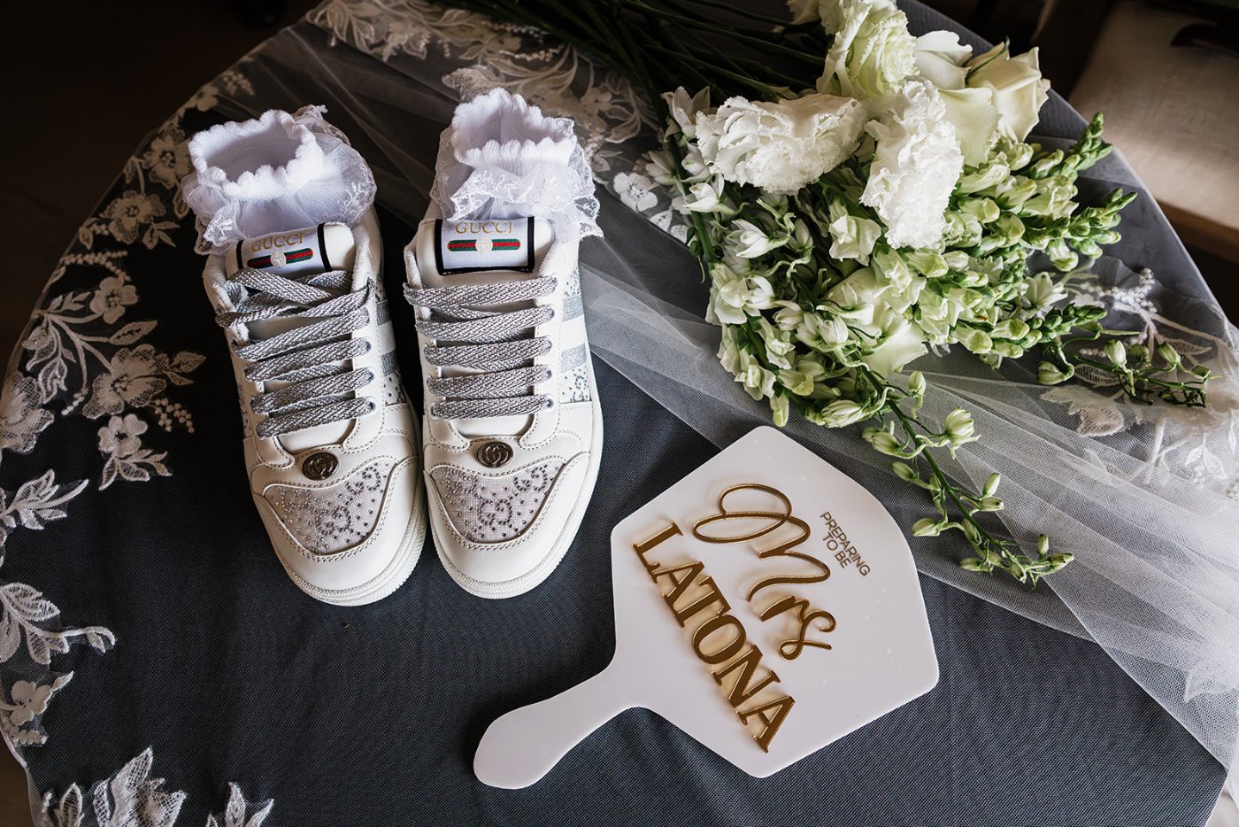 Custom bridal sneakers with a hand fan
