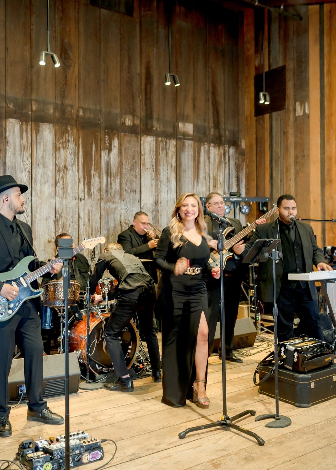Live wedding band performing at a barn reception