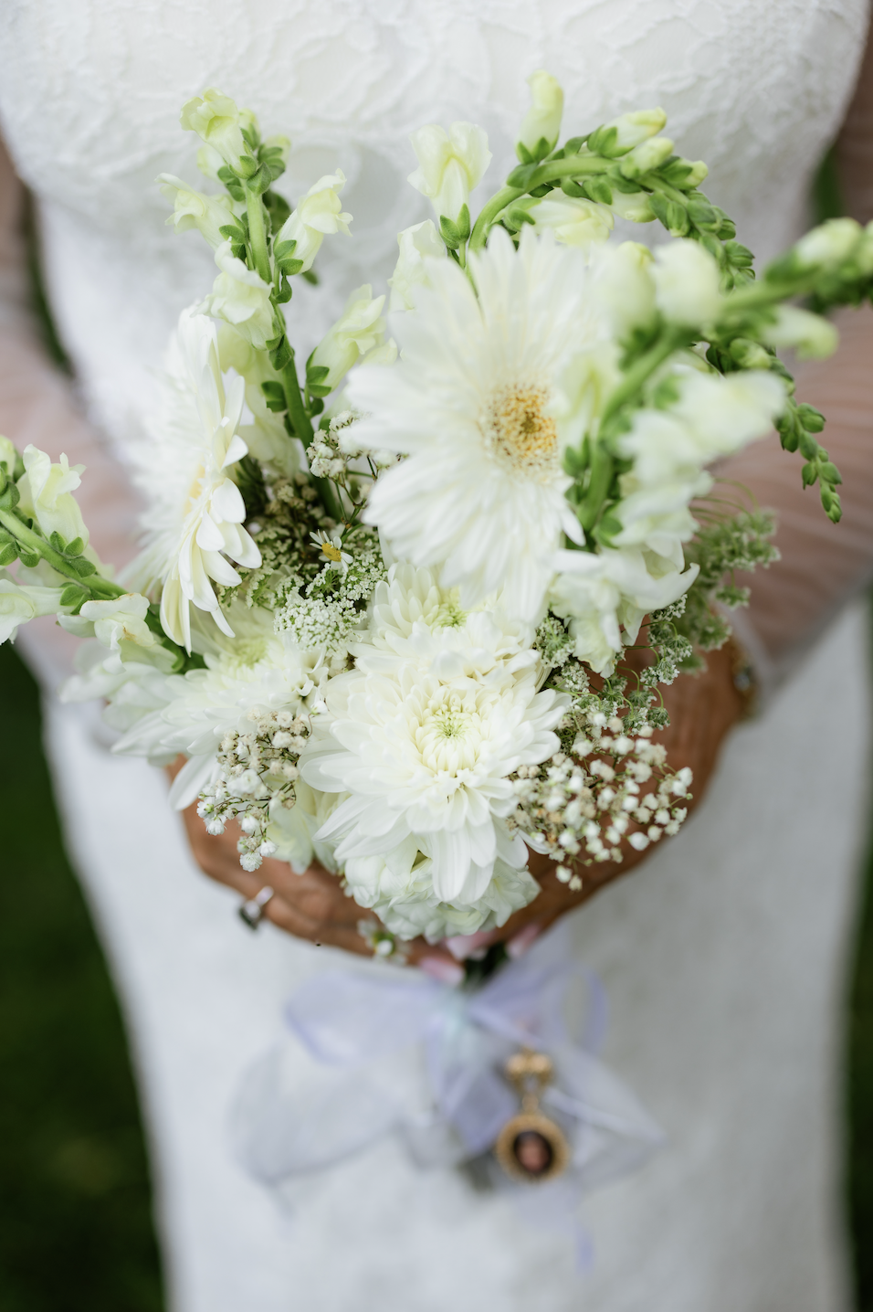 White garden bouquet with a memorial locket charm at a Maryland wedding