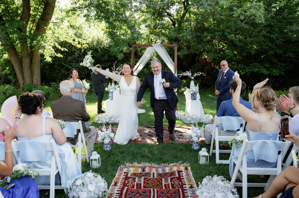 Maryland wedding cost, the couple celebrating on antique Turkish rugs lining the garden ceremony aisle in Bethesda