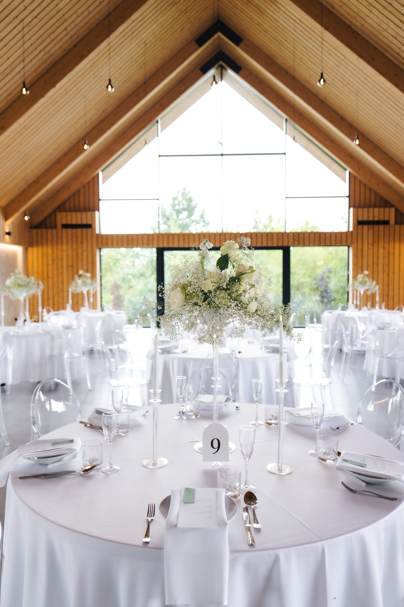 White and green wedding tablescape under the timber A frame at Samota Pierre