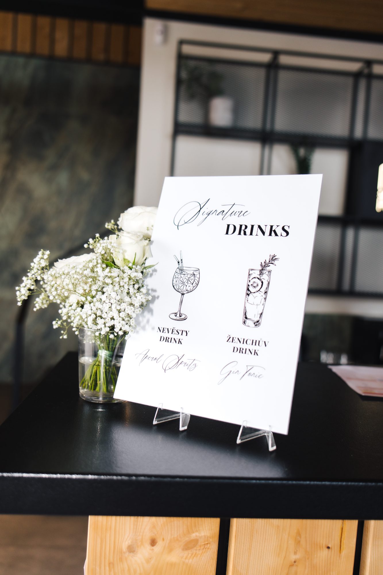 Signature drinks sign with white roses and lily of the valley at a Samota Pierre wedding